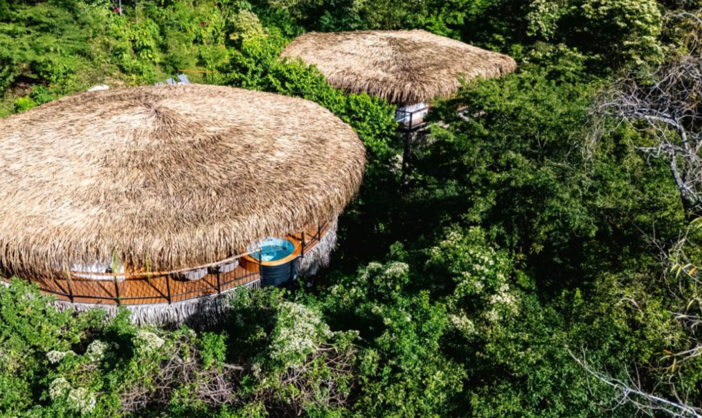 Nosara Treehouses — aerial view of thatched canopy residences